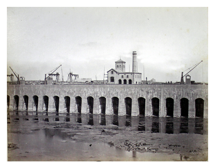 Looking across the dock at the engine house, prior to opening of dock in 1865. Note massive construction of dock walls. 82.24