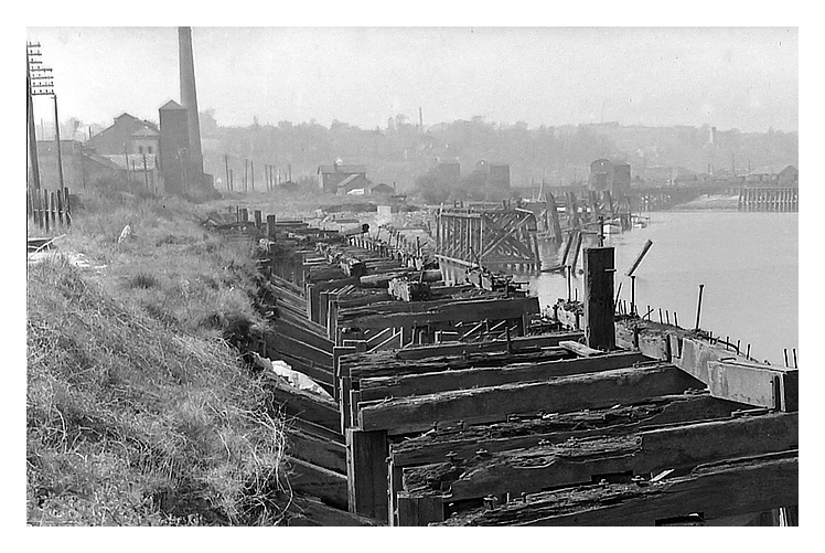 1950's - A view upstream of the slipway and gridiron location showing the derelict timber shoring adjacent to Penarth Dock but also sharing the banks of the River Ely Estuary. 