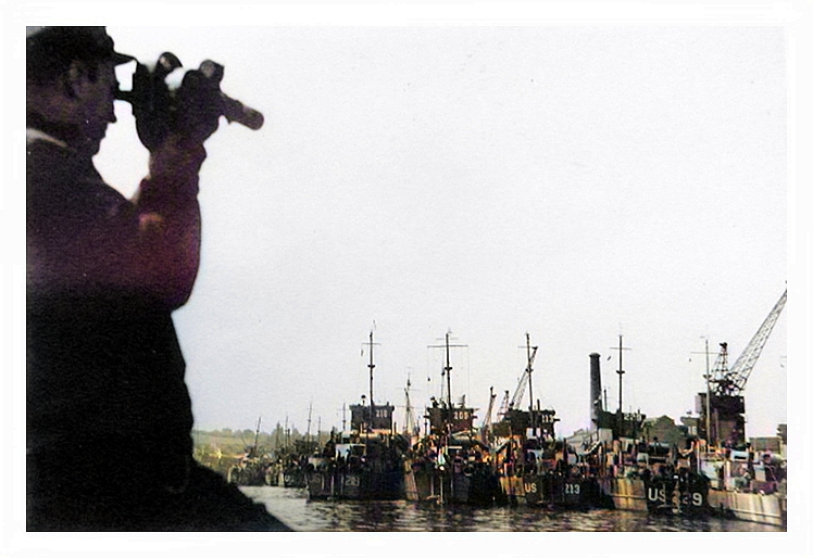 A US officer takes a sighting whilst in the Penarth Dock are many LST's.