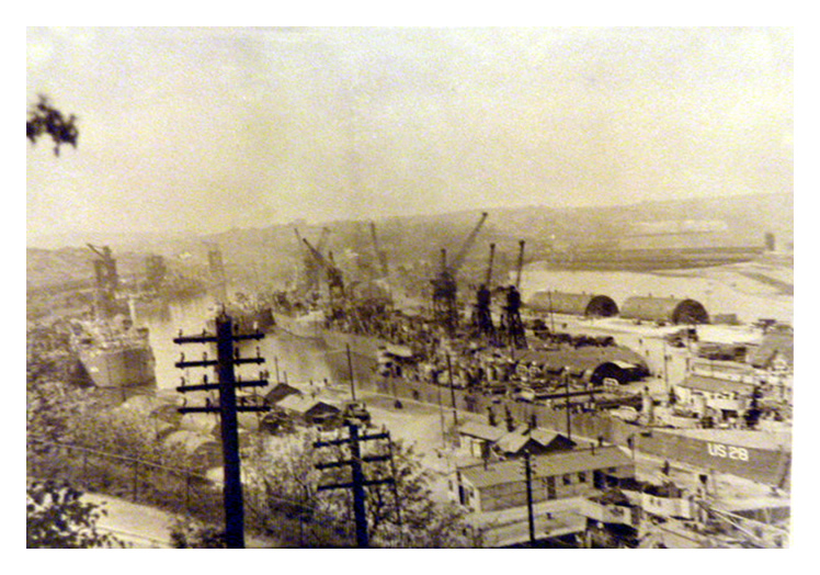 May 1944 - A slightly grainy panorama of the Penarth Dock taken from just above Dock Road. LST US-28 is passing through the lock toward the basin.