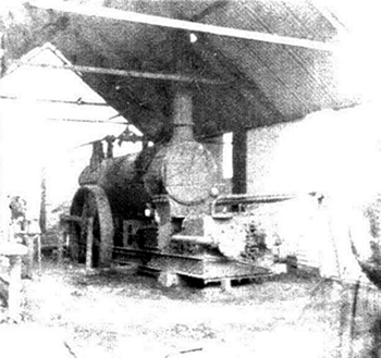 A photograph of the steam driven air compressor mounted at the surface which supplied the air used in the construction of the River Ely Subway. 