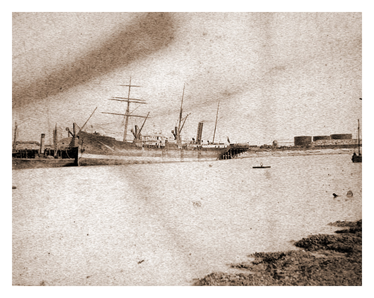 1888 - A photograph of vessels moored at the iron ore wharf just downstream from the coal tips and the Victoria Wharf.