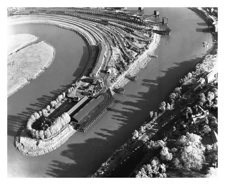 1955 - An aerial view of the meandering River Ely with the Victoria Wharf of the South Wales Warehouses Limited with associated warehouse and rail facilities.