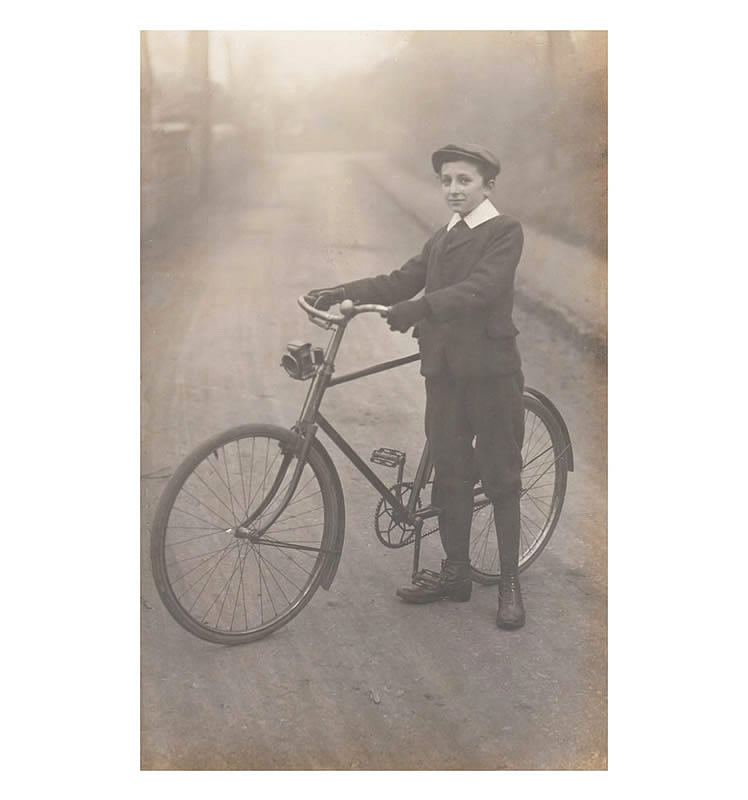 Photograph of a boy and a bicycle as published in postcard format by G. Wehrley & Co., 97, Glebe Street, Penarth, S. Wales. 