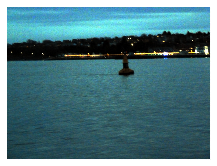 The Return - as the light fades we return to the barrage. Distant are the lights of Penarth Pier.